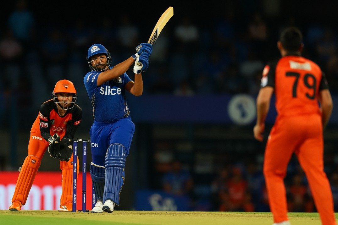 IPL cricket match action with players competing in a packed stadium